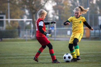 Two girls playing football