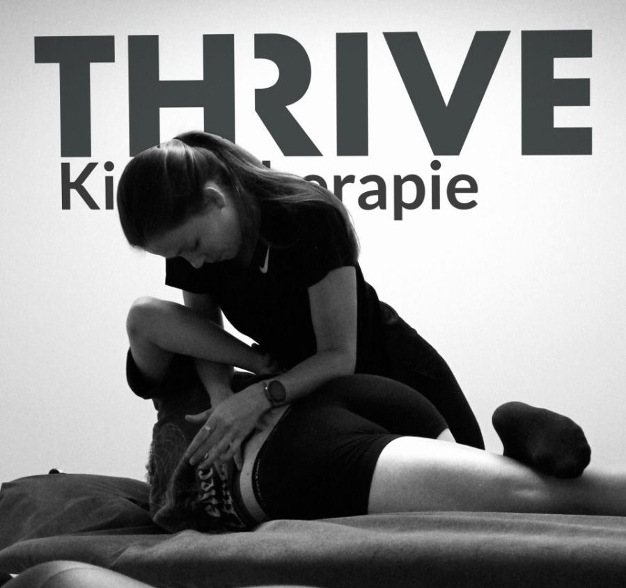 Jessica Van Melkebeke working with a patient. Behind her, in the wall, the logo of her practice: Thrive.